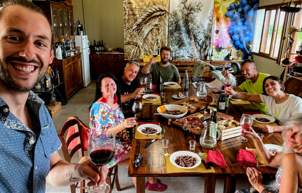 Group of visitors having an amazing meal while Marino takes a selfie of them all